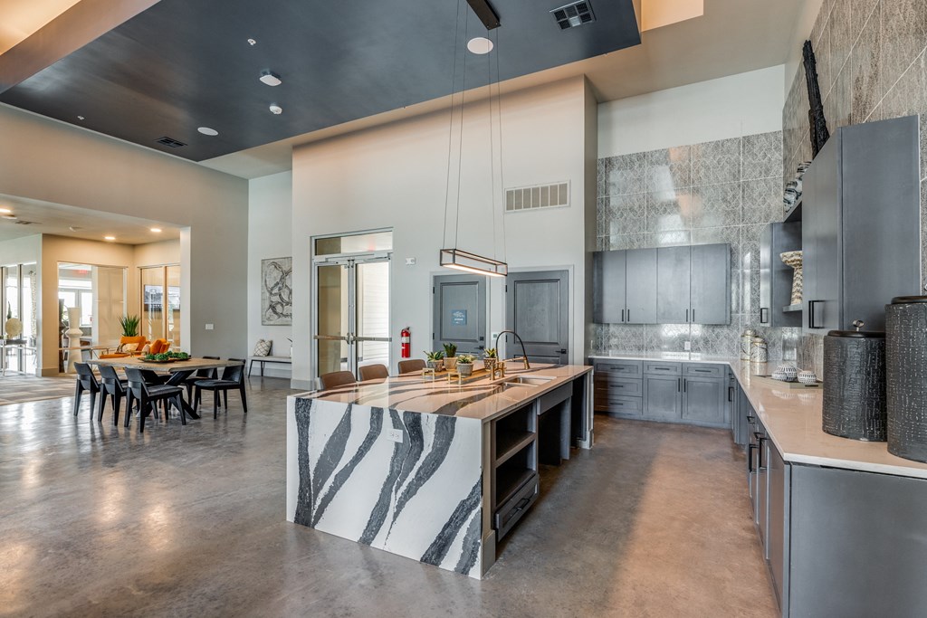 a large kitchen with a large island and a dining table