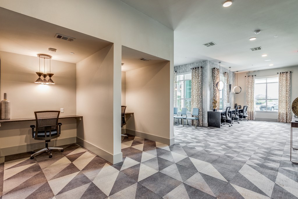 a conference room with a desk and chairs and a large window