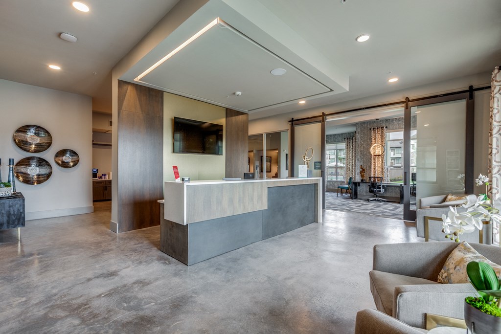 the lobby of a condo with a reception desk