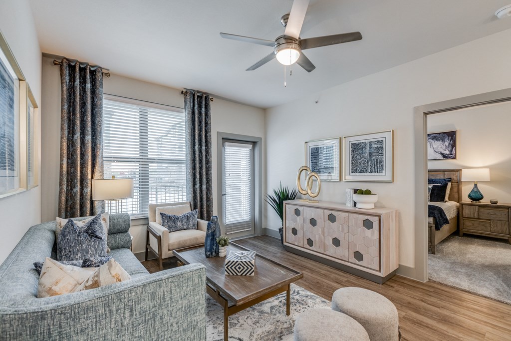 a living room with a ceiling fan and a couch