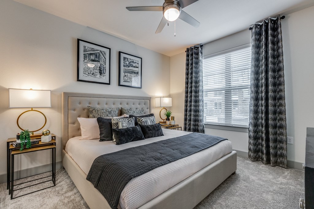 a bedroom with a large bed and a ceiling fan