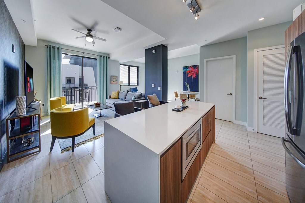 a kitchen with a large island and a living room with a couch