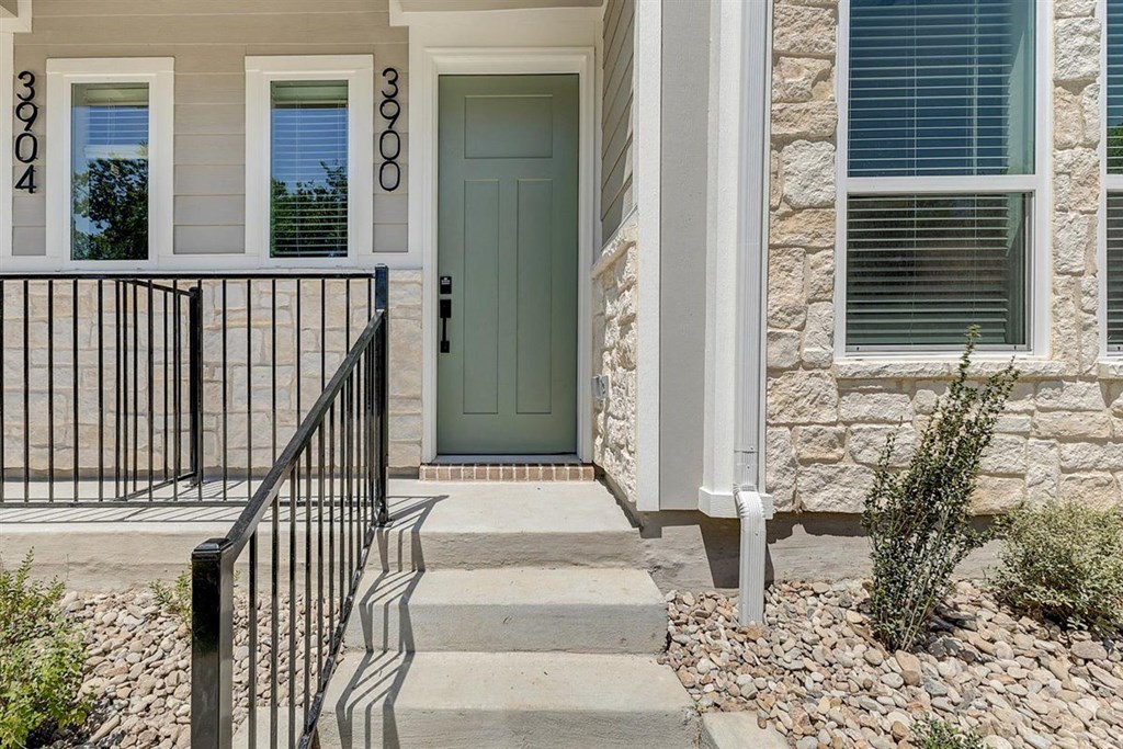 a green door on a stone house with steps leading up to it