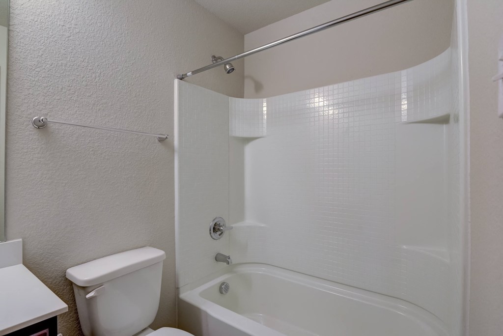 a bathroom with a tub and a toilet and a sink