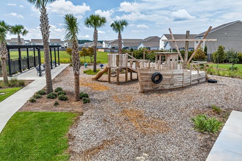 A playground with a slide and tire swing set.