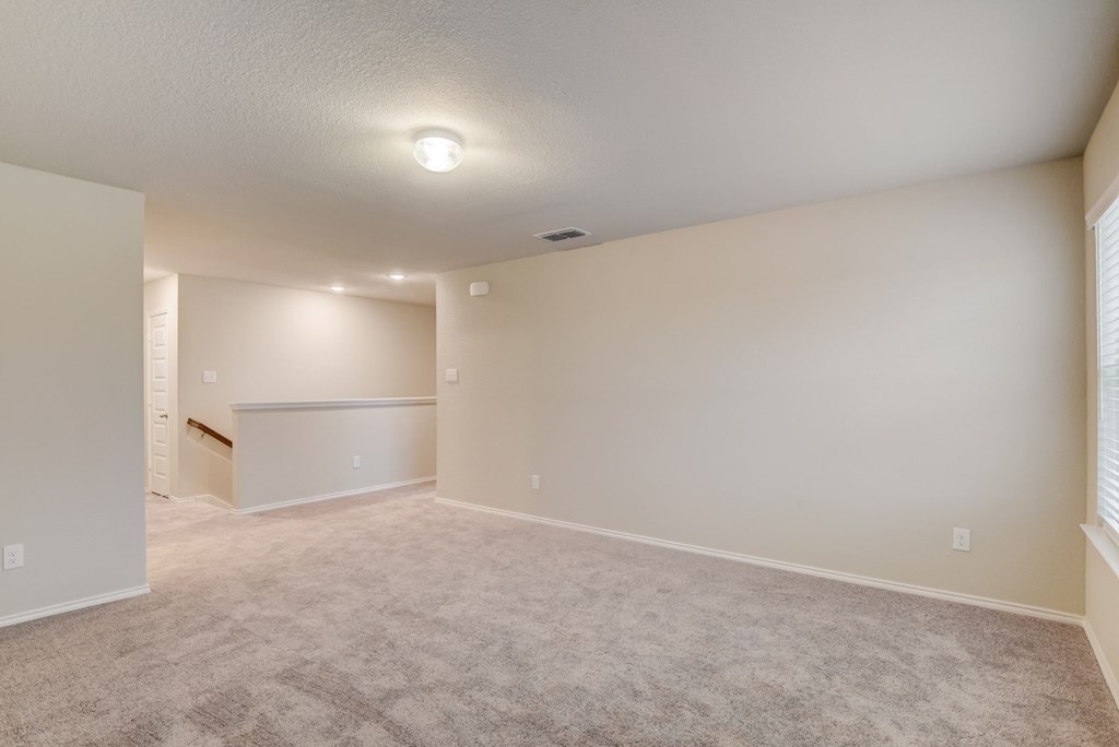 the spacious living room and dining room in a new home