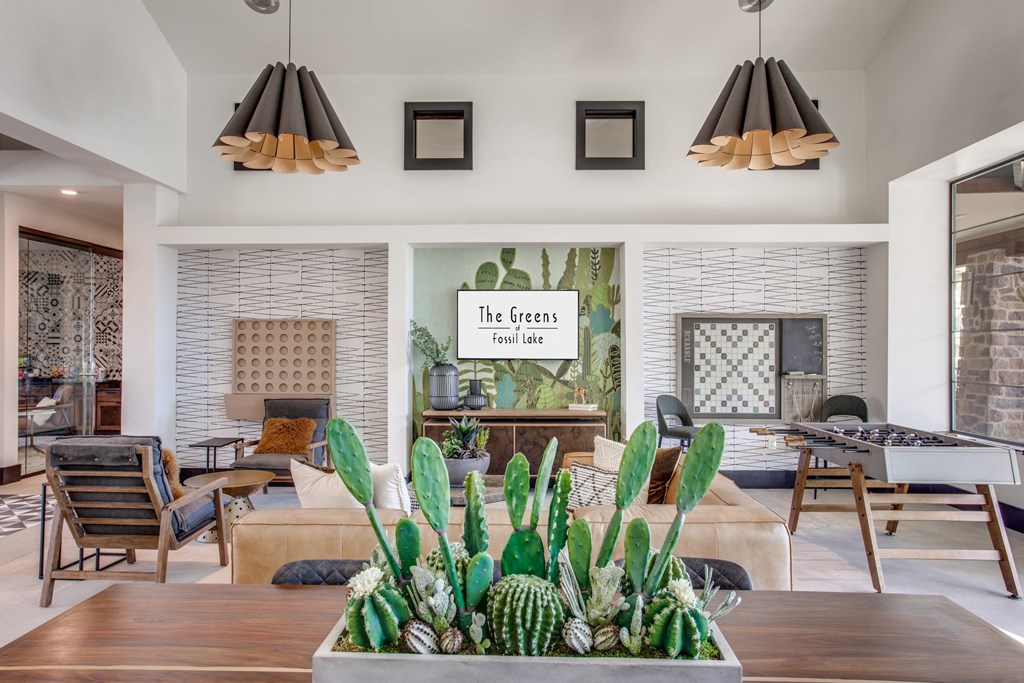 a living room filled with furniture and a table with plants