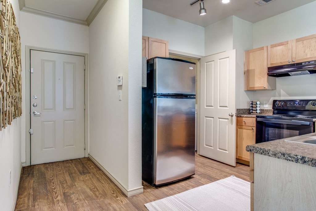 a kitchen with stainless steel appliances and wooden cabinets
