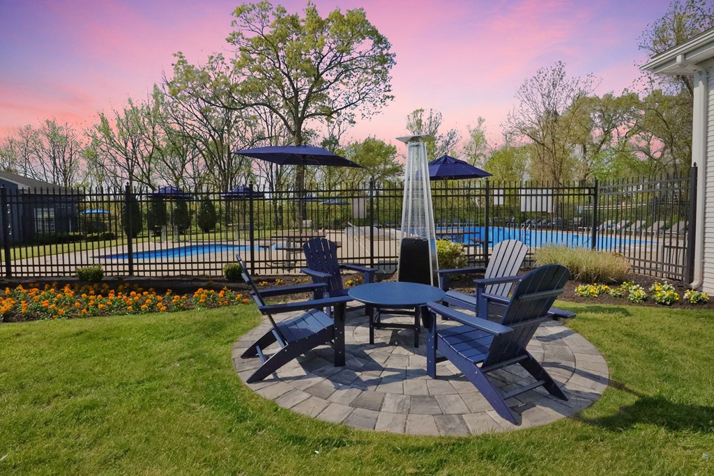 A backyard with a table and chairs set up for outdoor dining.
