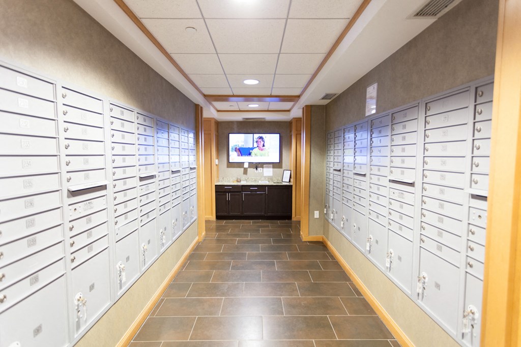 a view of mailboxes and a television in a hallway