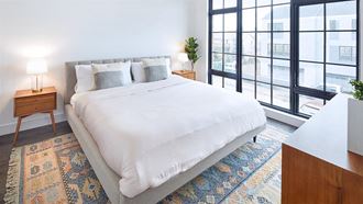Light filled bedroom with floor to ceiling windows and modern furnishings - Photo Gallery