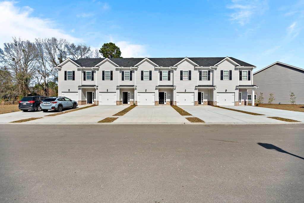 a large white building with cars parked in front of it