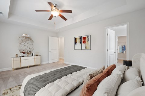 Harris Trail Luxury Townhomes for rent Richmond Hill, GA photo of a bedroom with a large bed and a ceiling fan