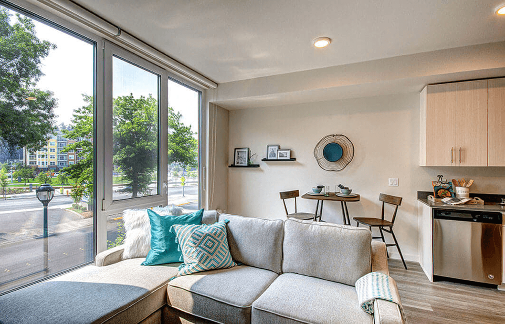 a living room with a couch in front of a window