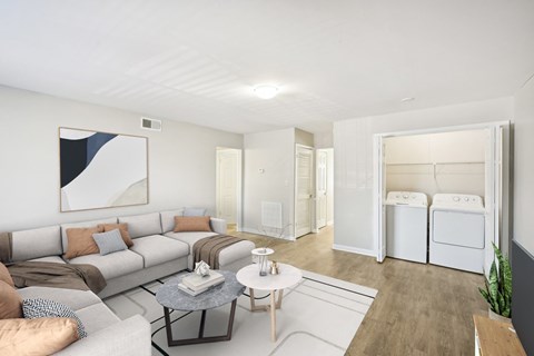 A modern living room with a grey sofa and a coffee table.