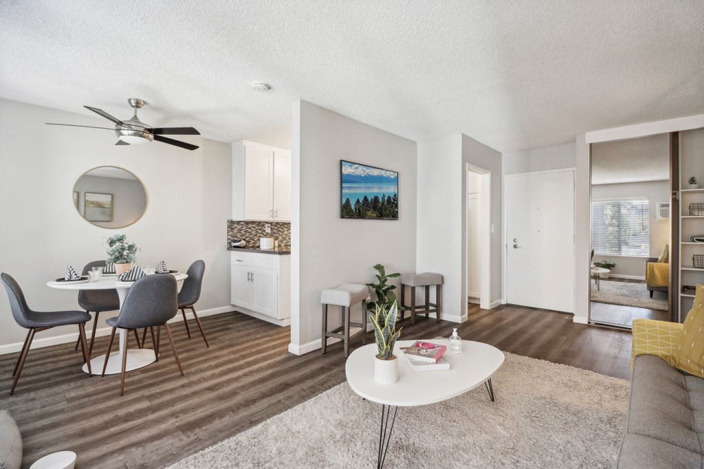 A living room with a dining table and chairs.