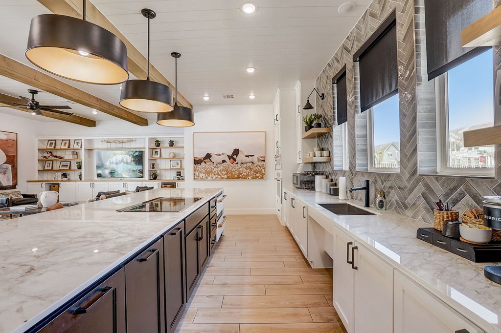 a large kitchen with marble counter tops and stainless steel appliances