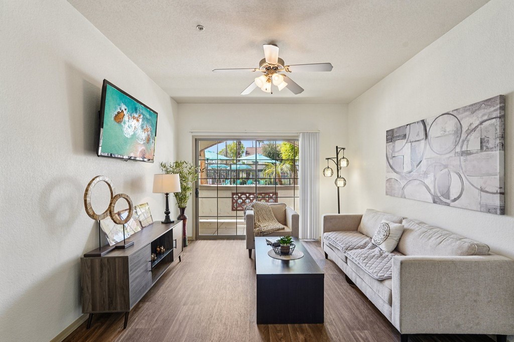 A living room with a couch, a coffee table, and a painting on the wall.