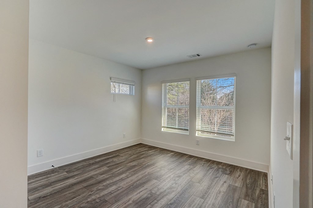 Henley Avondale Homes for rent in Avondale Estates, GA photo of a living room with white walls and wood flooring and a window
