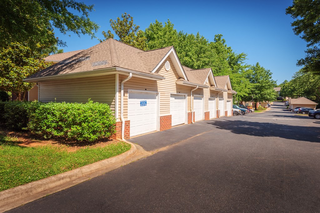 a row of houses with garages on the side of a street