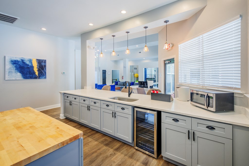 a kitchen with an island and a microwave and a sink