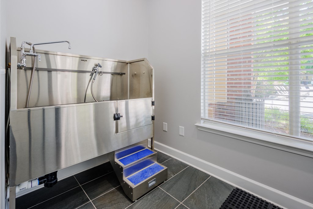 a large stainless steel refrigerator in a kitchen next to a window