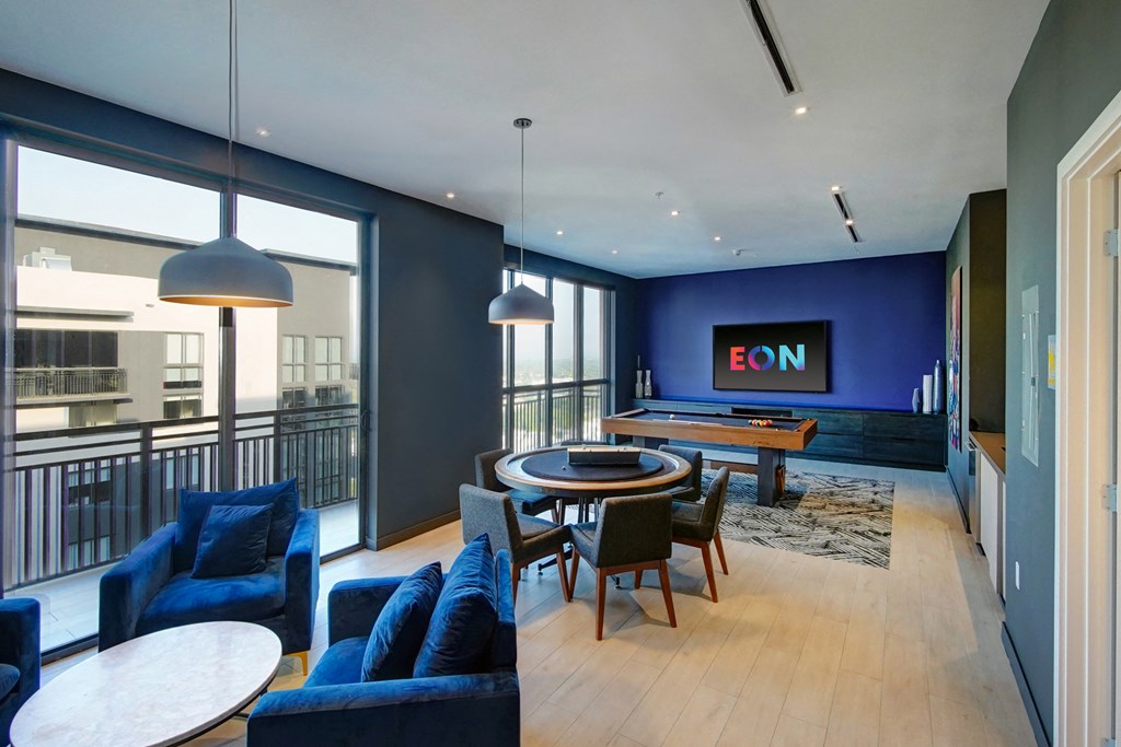 a living room with blue furniture and a pool table