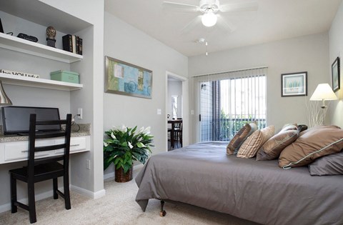 an example of a bedroom with a bed and a desk
