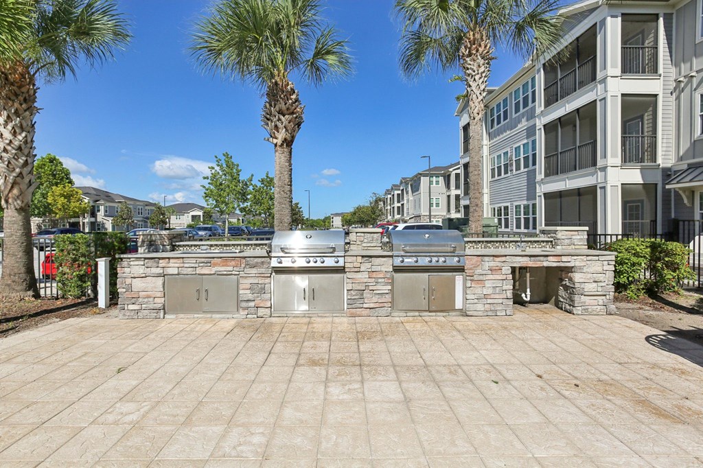 Outdoor grill area with seating at Lotus at Starkey Ranch in Odessa, Florida.