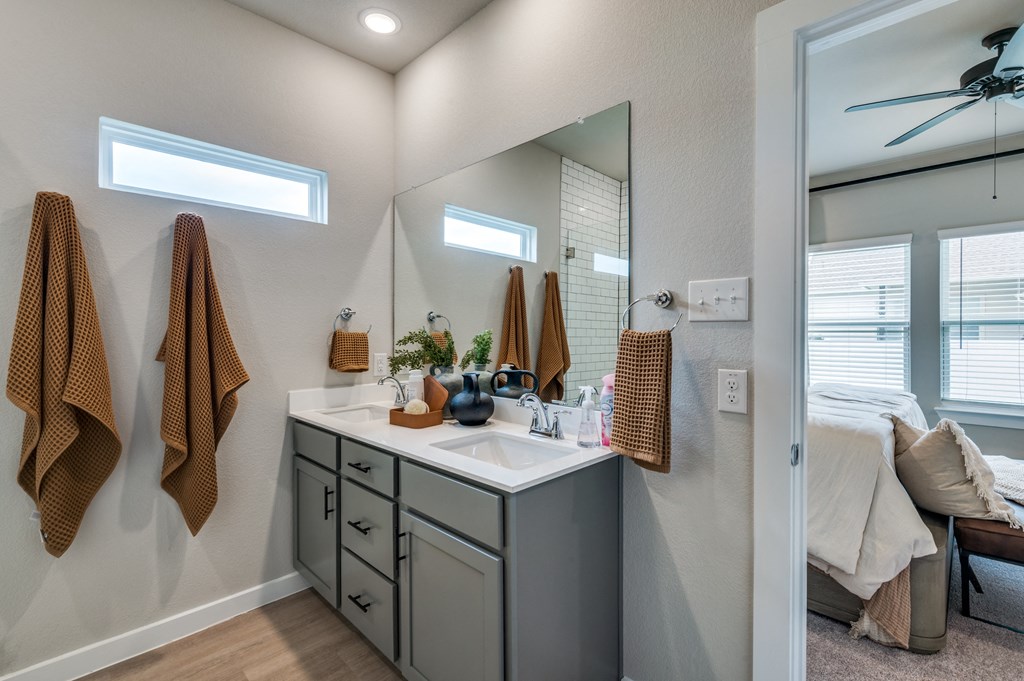 the private bathroom is equipped with a large mirror and a sink