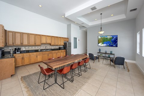 A modern kitchen with a dining table and chairs.