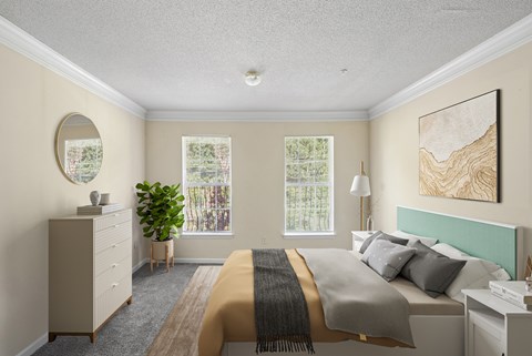 A bedroom with a bed, dresser, and window.