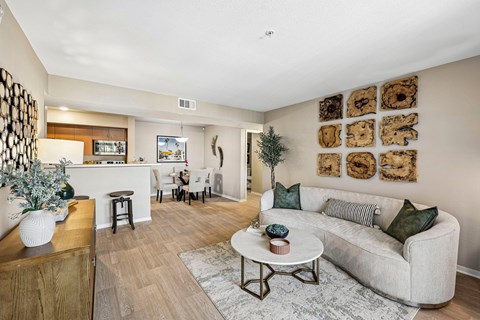 A living room with a white couch and a coffee table.