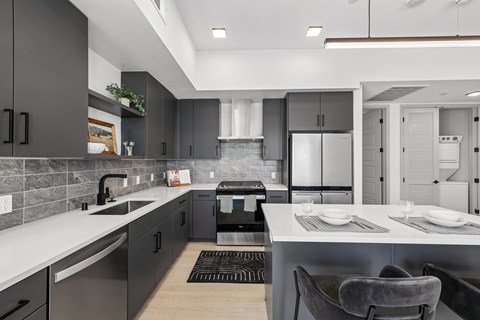 A modern kitchen with a dining area.