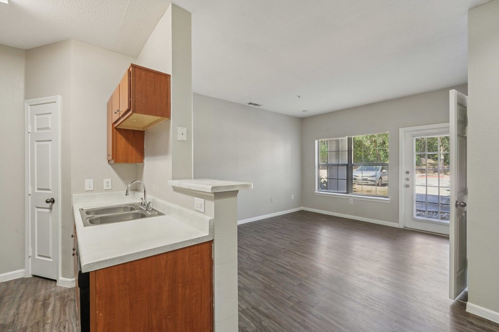 A kitchen with a sink and a counter.