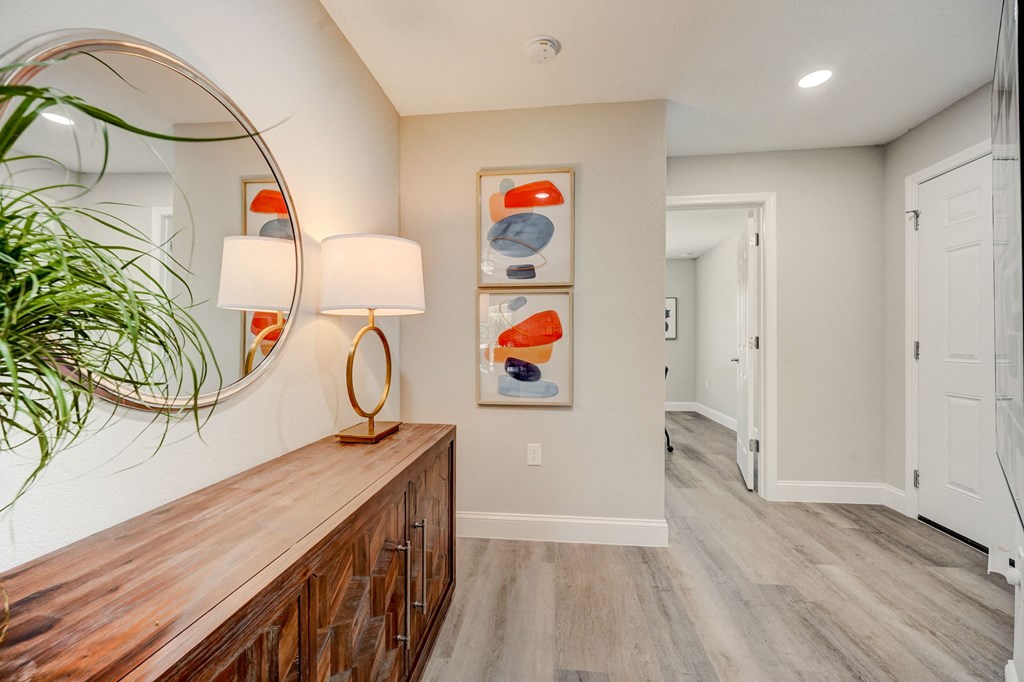Spacious hallway inside a residence at The Groves at Lake Ella in Lady Lake, Florida, a pet-friendly rental community.