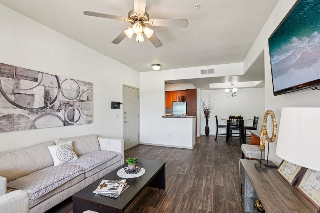 A living room with a grey couch and a coffee table.