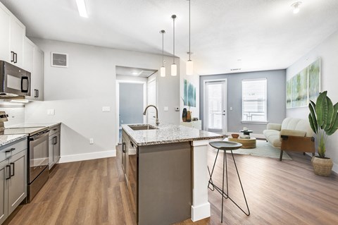 a kitchen with an island and a living room with a couch