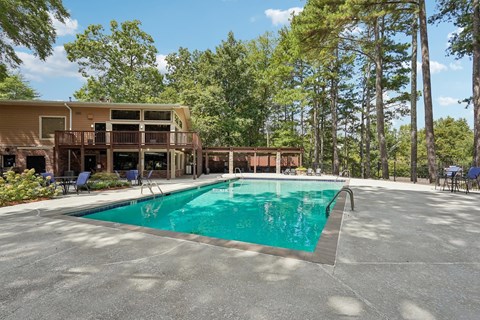 A large swimming pool in front of a resort.