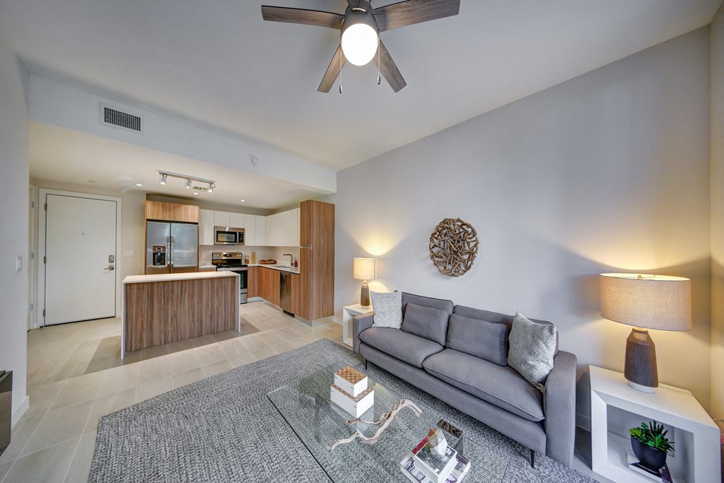 a living room with a couch and a ceiling fan