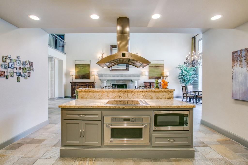 a large kitchen with stainless steel appliances and granite counter tops