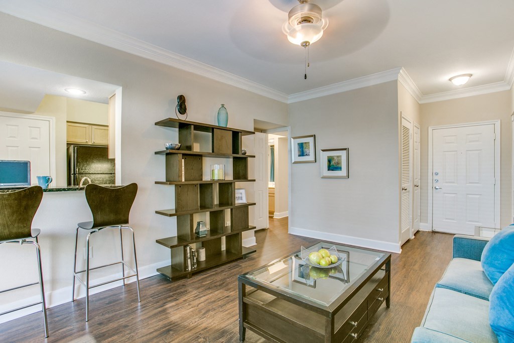 a living room with a couch and a glass coffee table