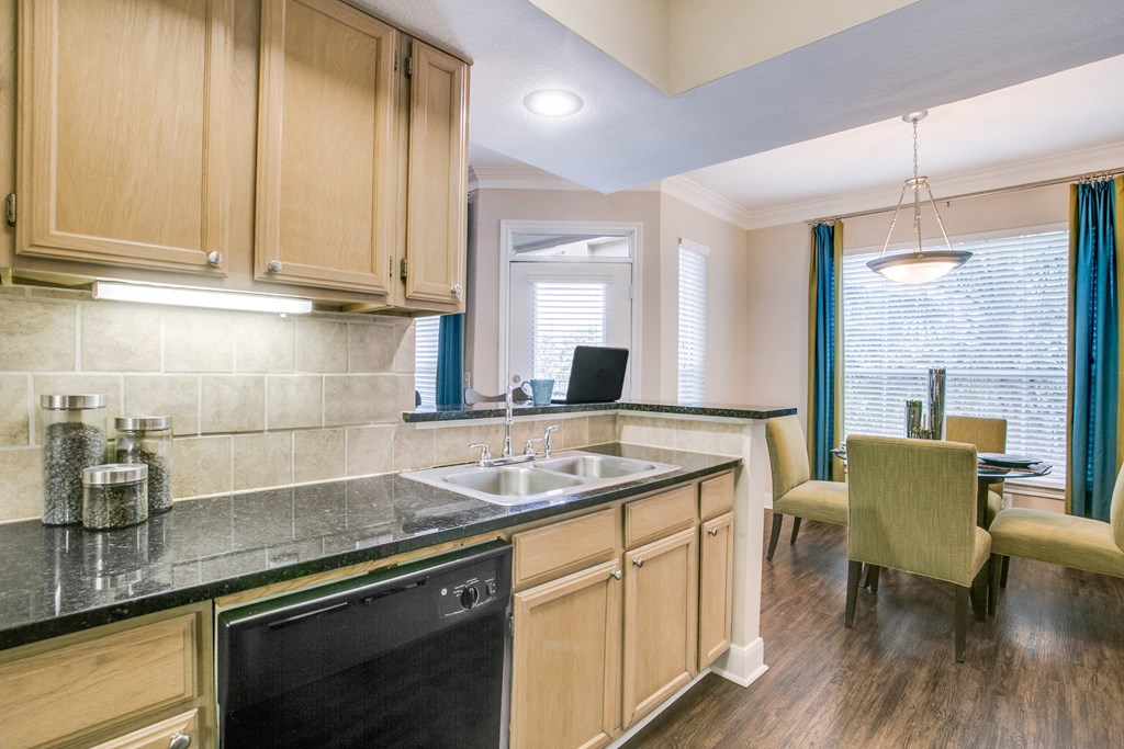 a kitchen with wooden cabinets and a sink and a window
