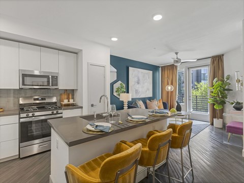 A modern kitchen with a dining table and chairs.