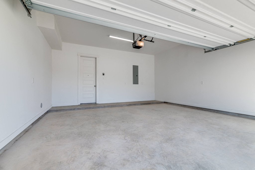 an empty room with white walls and a white door