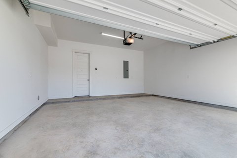 an empty room with white walls and a white door