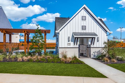 a white home with a walkway and a wooden fence