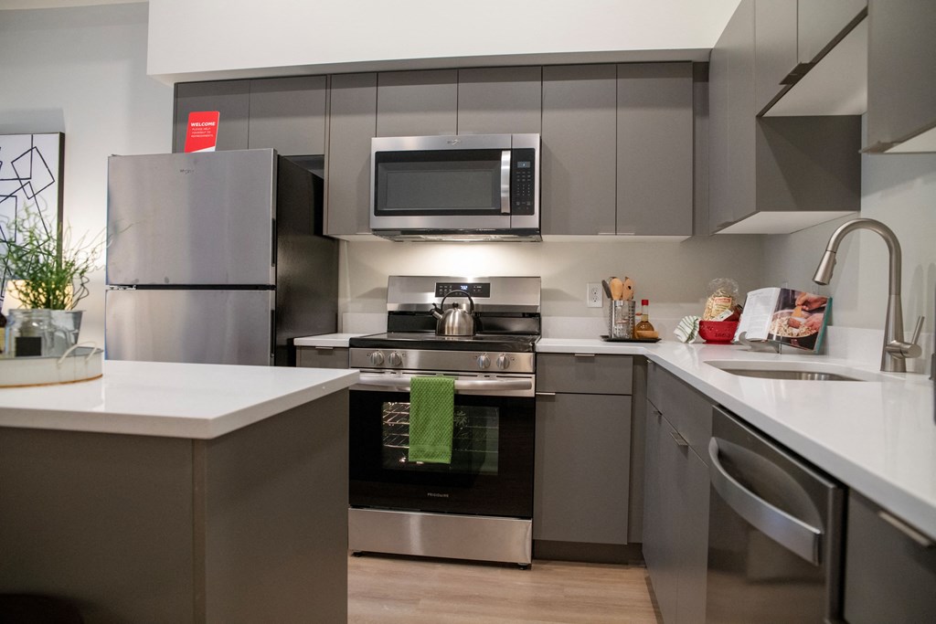 a kitchen with stainless steel appliances and a white counter top