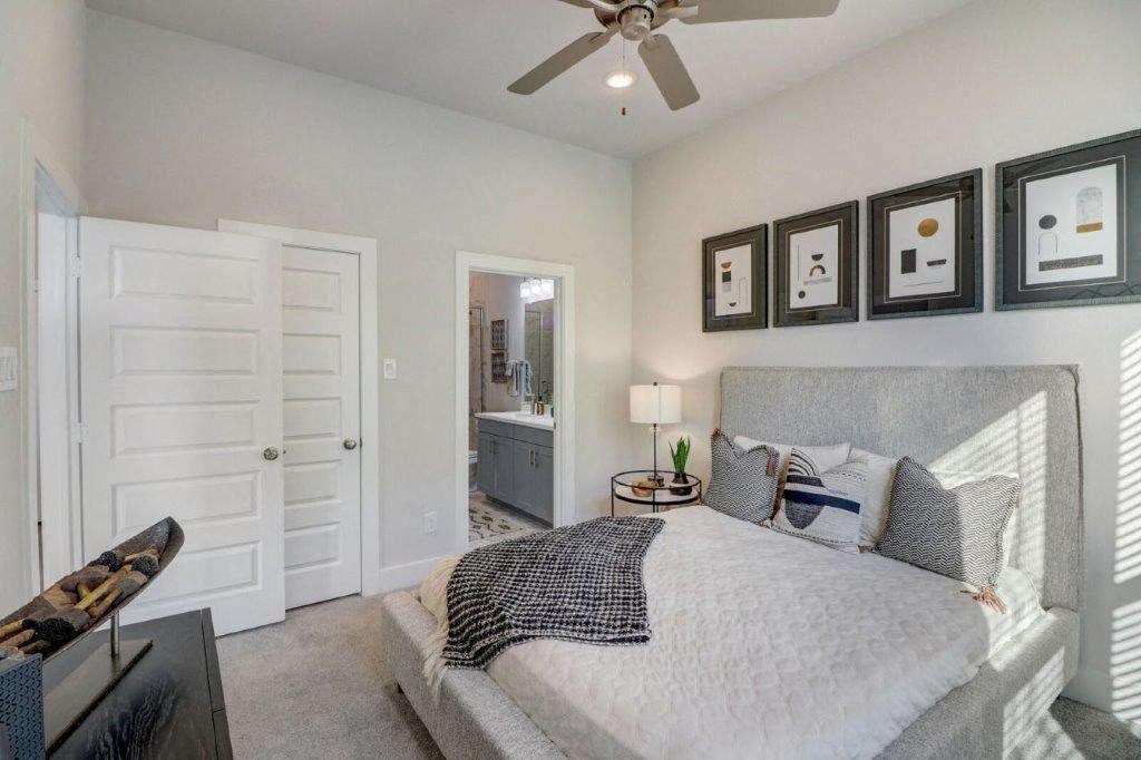 a bedroom with a bed and a ceiling fan