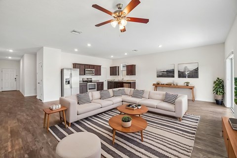 A living room with a striped rug and a white couch.
